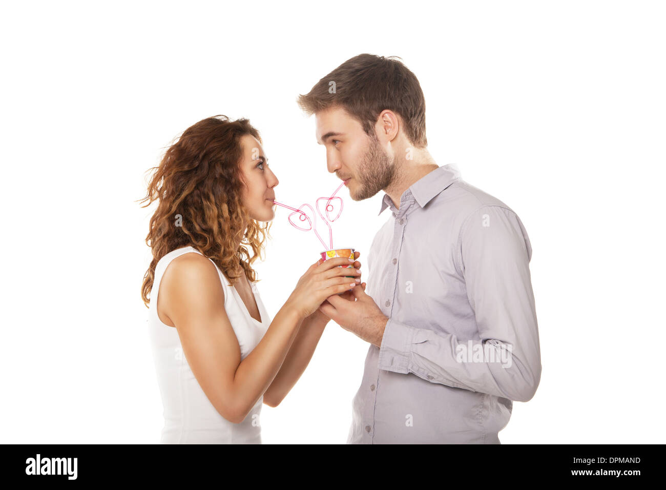 couple in love drink from the same glass isolated on white Stock Photo