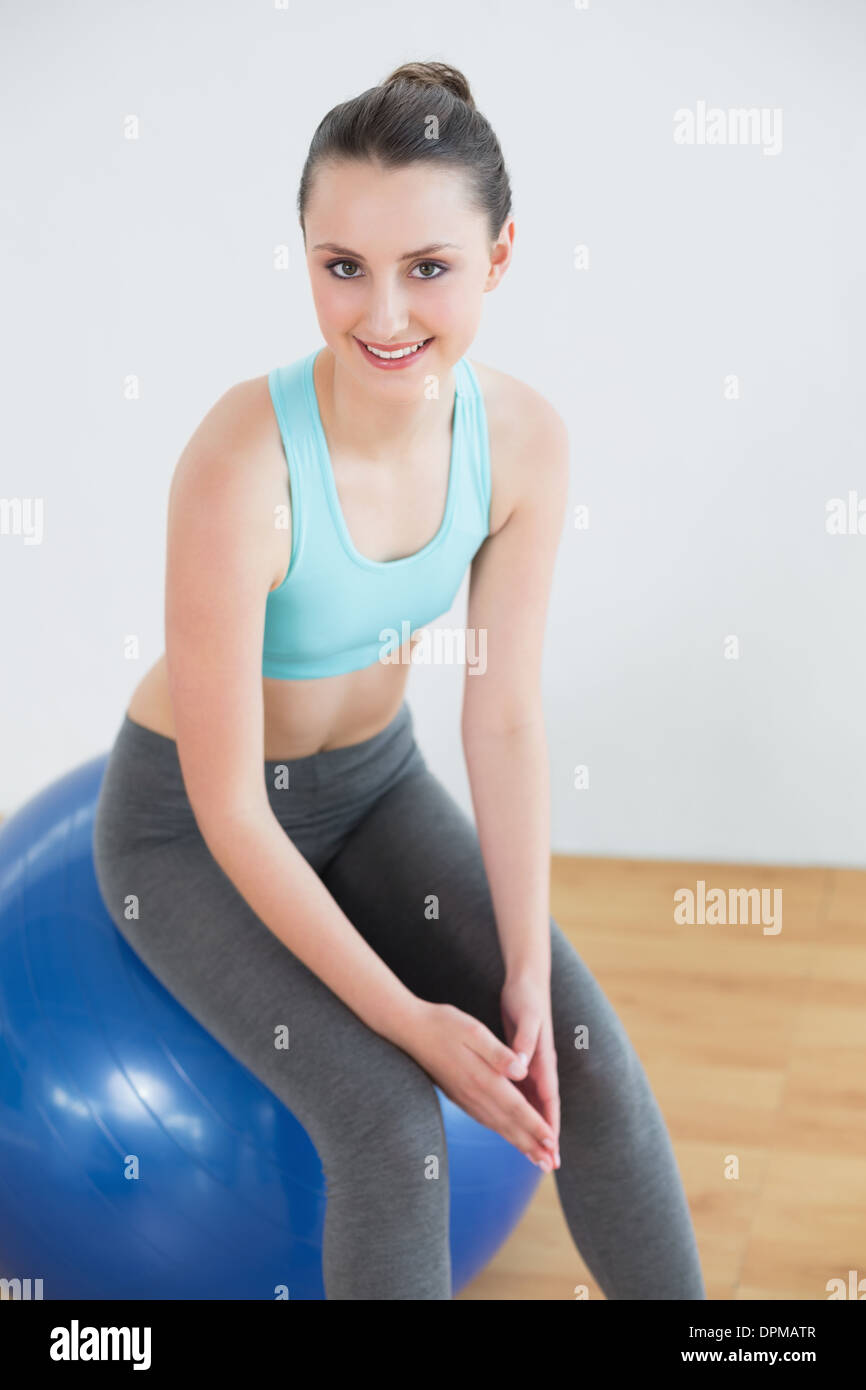 Fit woman sitting on exercise ball in fitness studio Stock Photo - Alamy