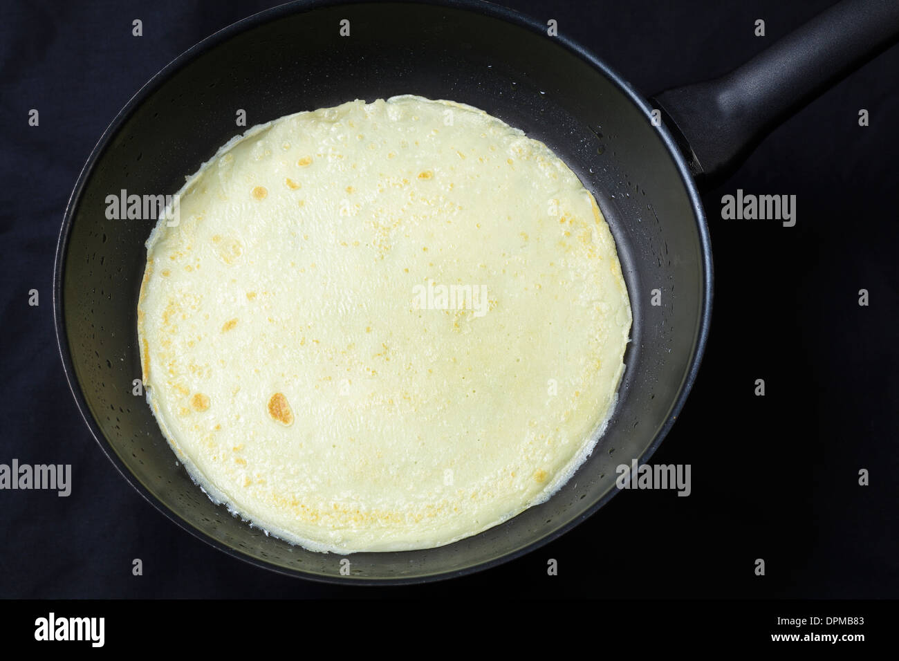 Pancake in frying pan Stock Photo
