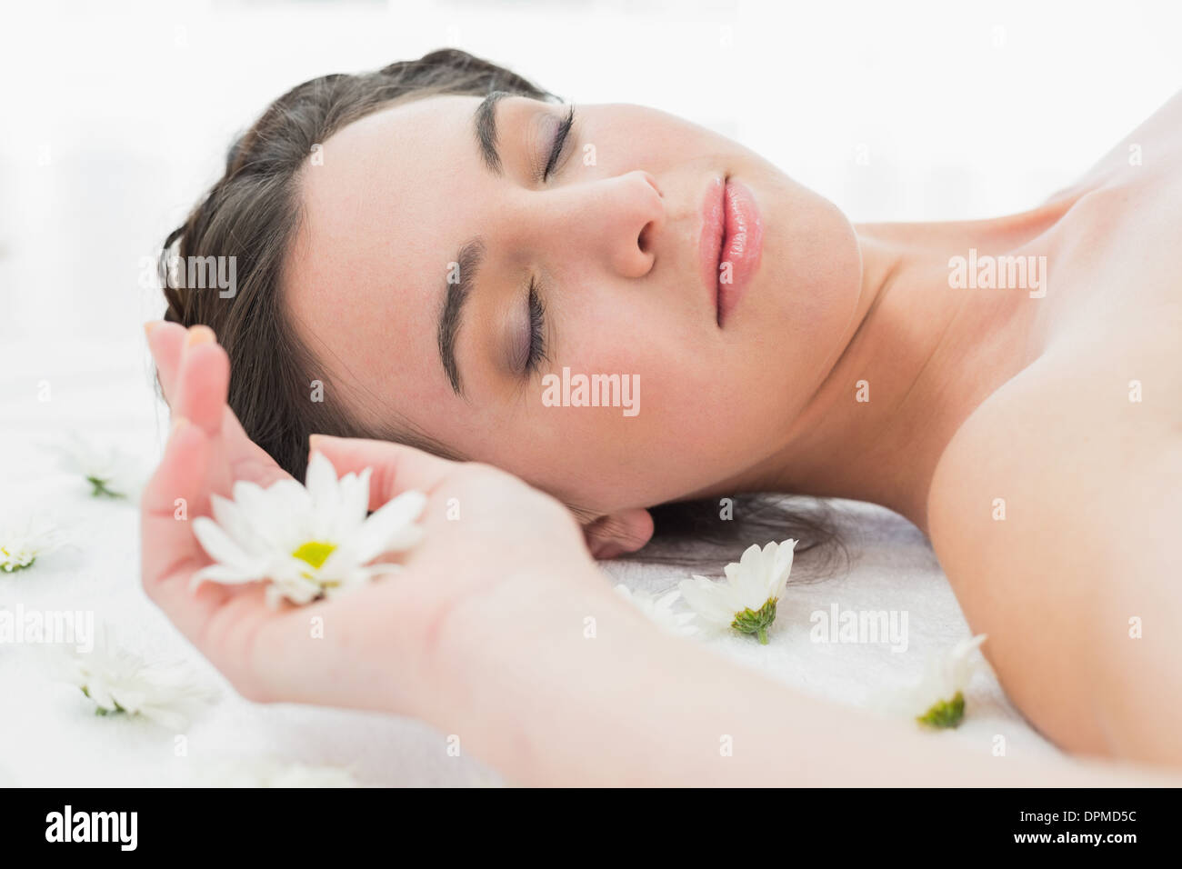Beautiful woman with eyes closed and flowers in beauty salon Stock ...