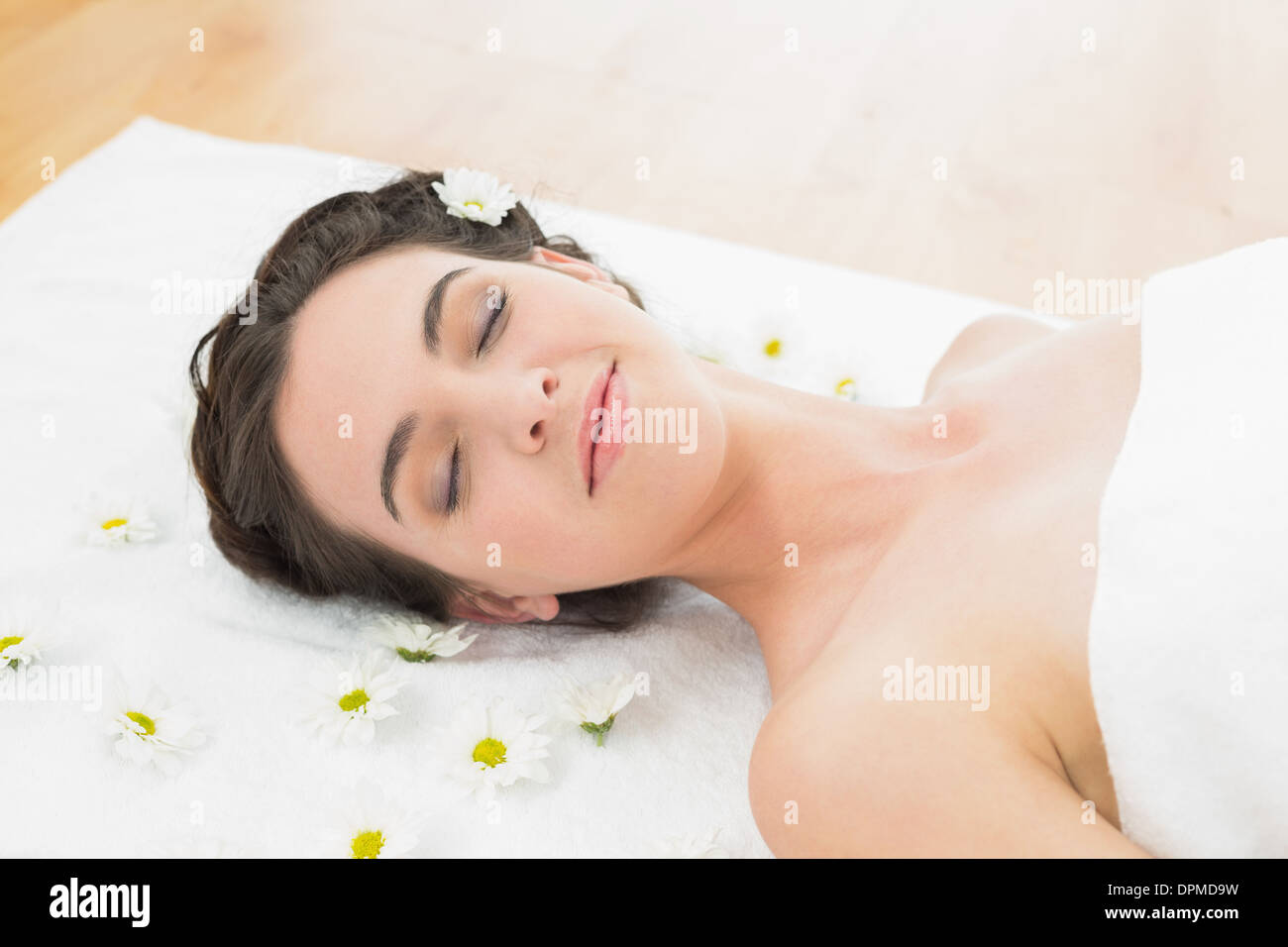 Beautiful woman with eyes closed and flowers in beauty salon Stock ...