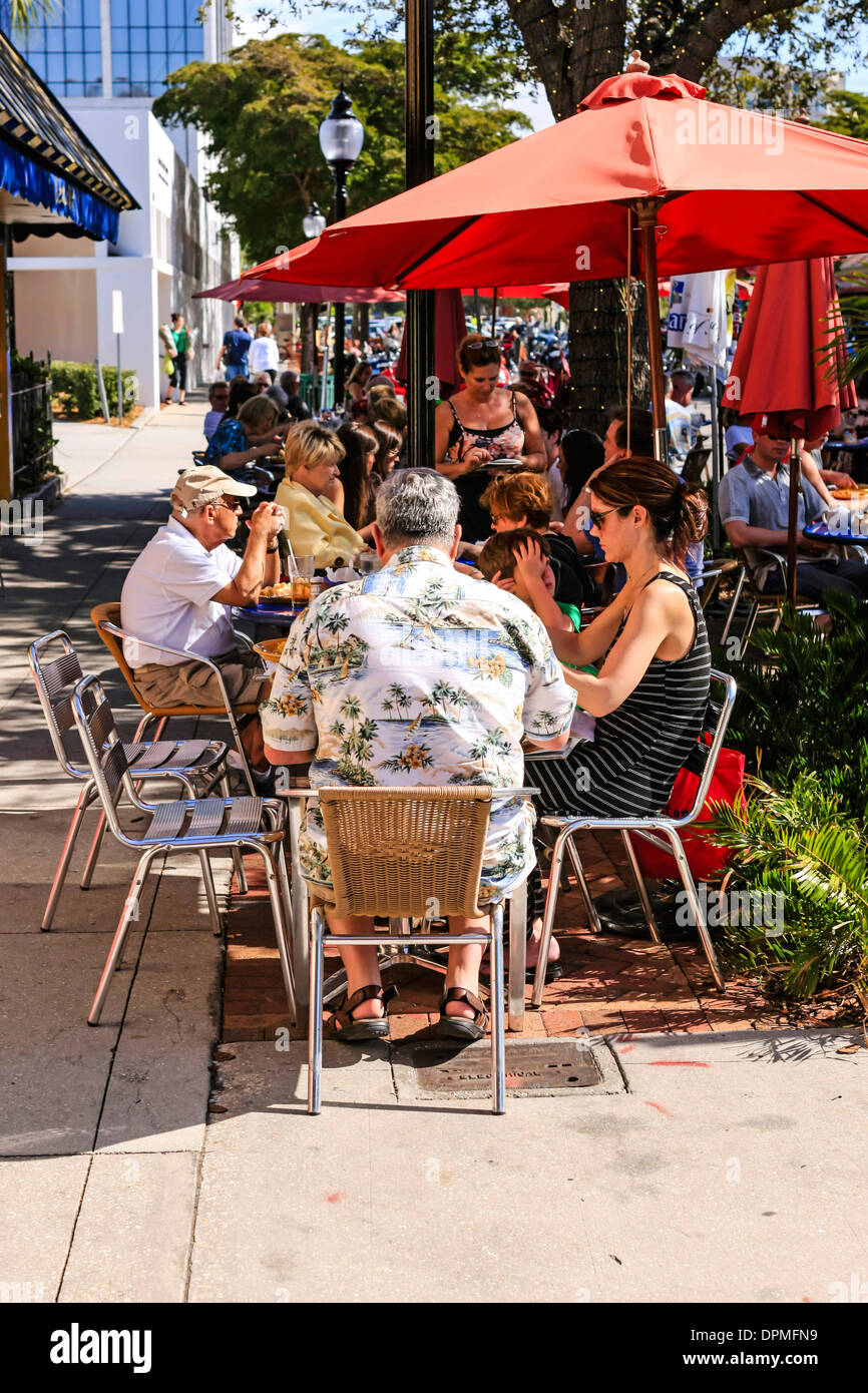 People enjoying the winter sunshine in Florida by eating Al Fresco at a sidewalk cafe Stock Photo