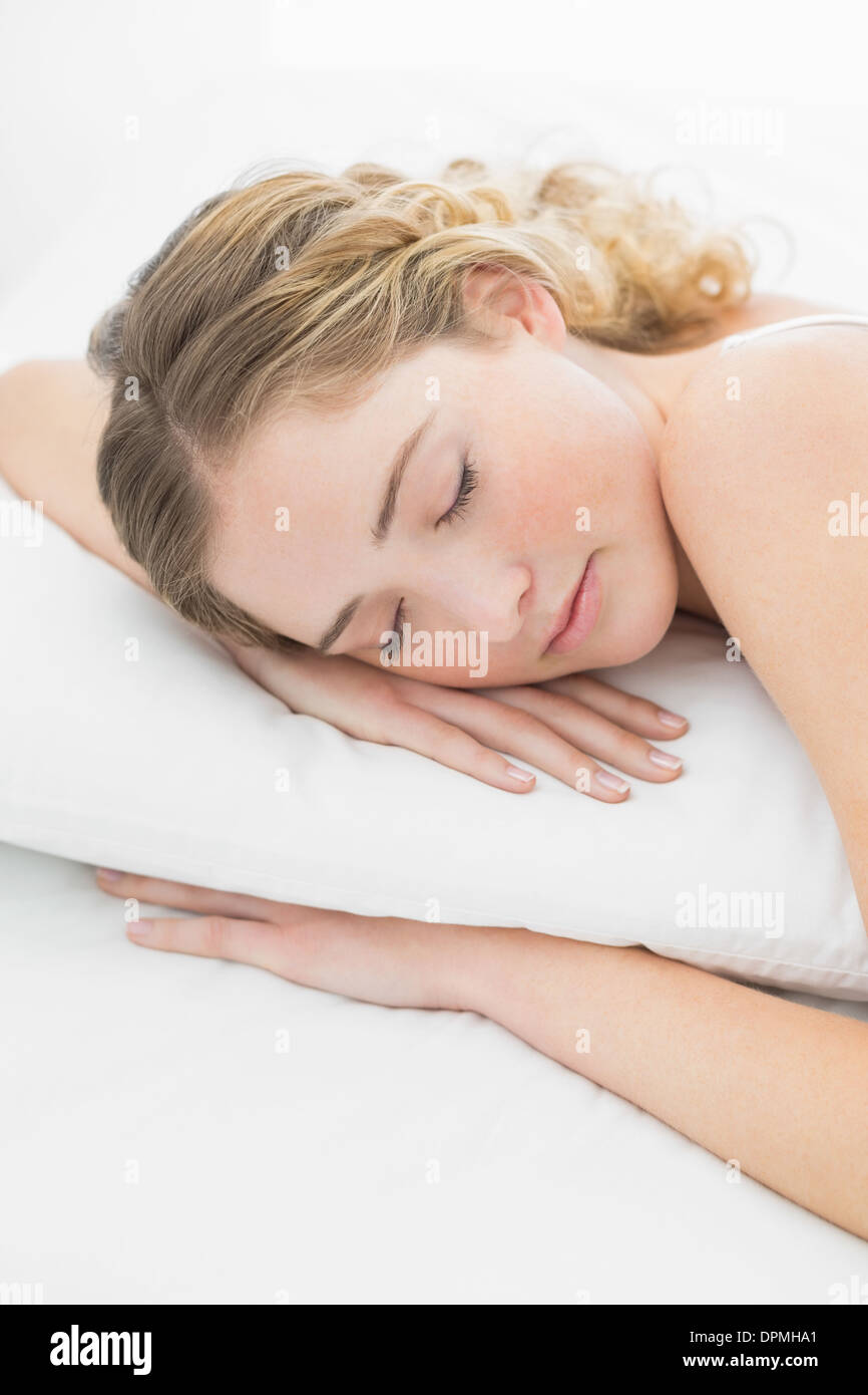 Pretty peaceful blonde lying in bed slumbering Stock Photo