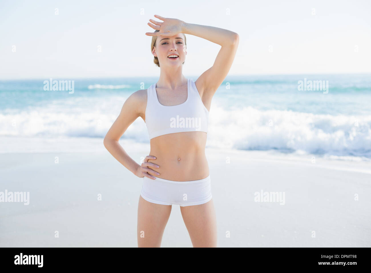 Cheerful slender woman touching her forehead Stock Photo