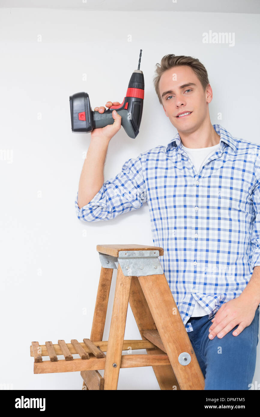Handyman using cordless drill to the ceiling Stock Photo