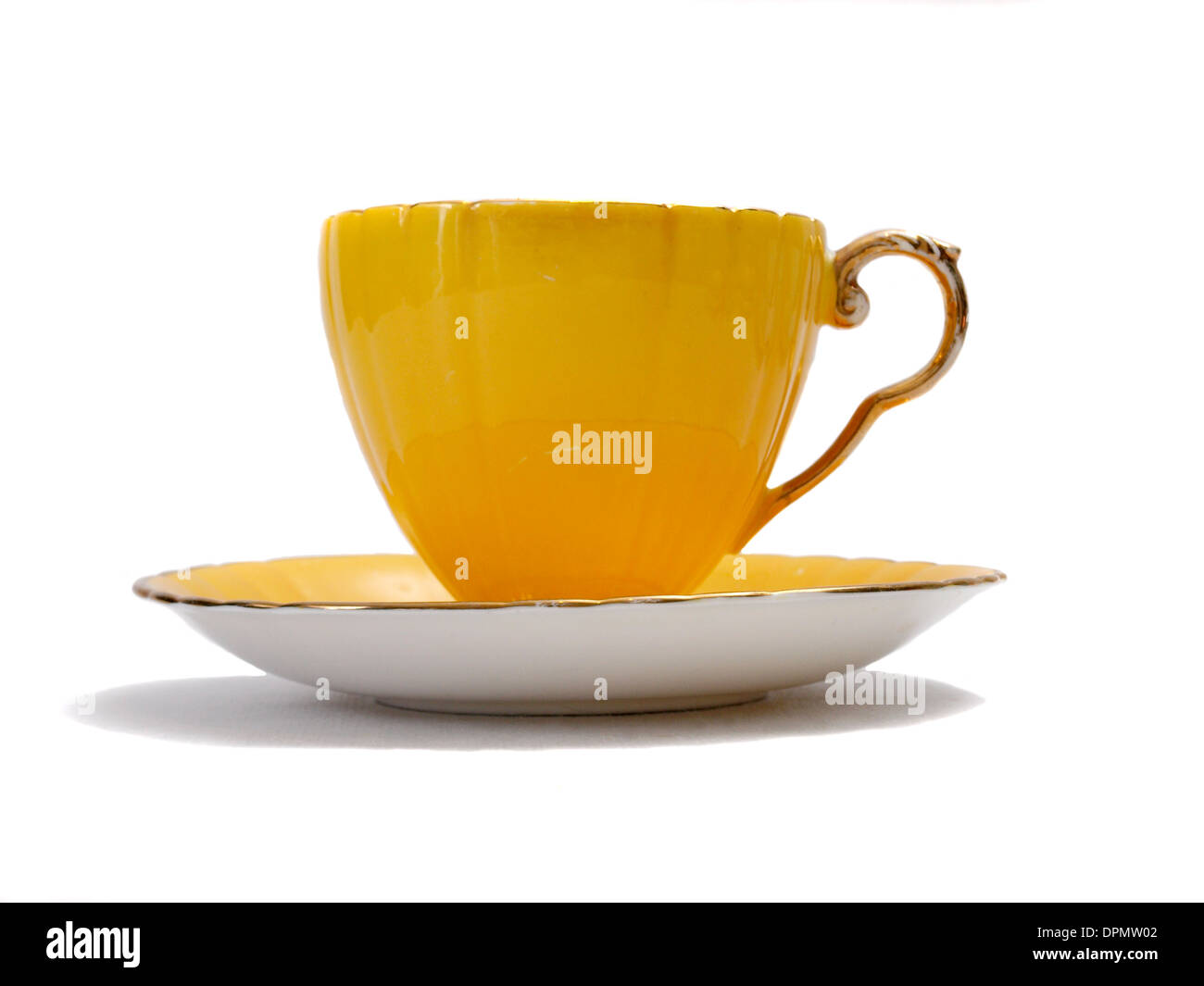 Yellow china tea cup on a white background. Stock Photo