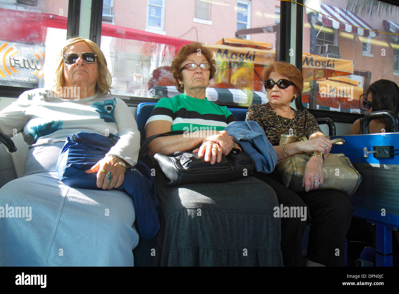 Public bus passenger passengers rider riders sitting hi-res stock ...