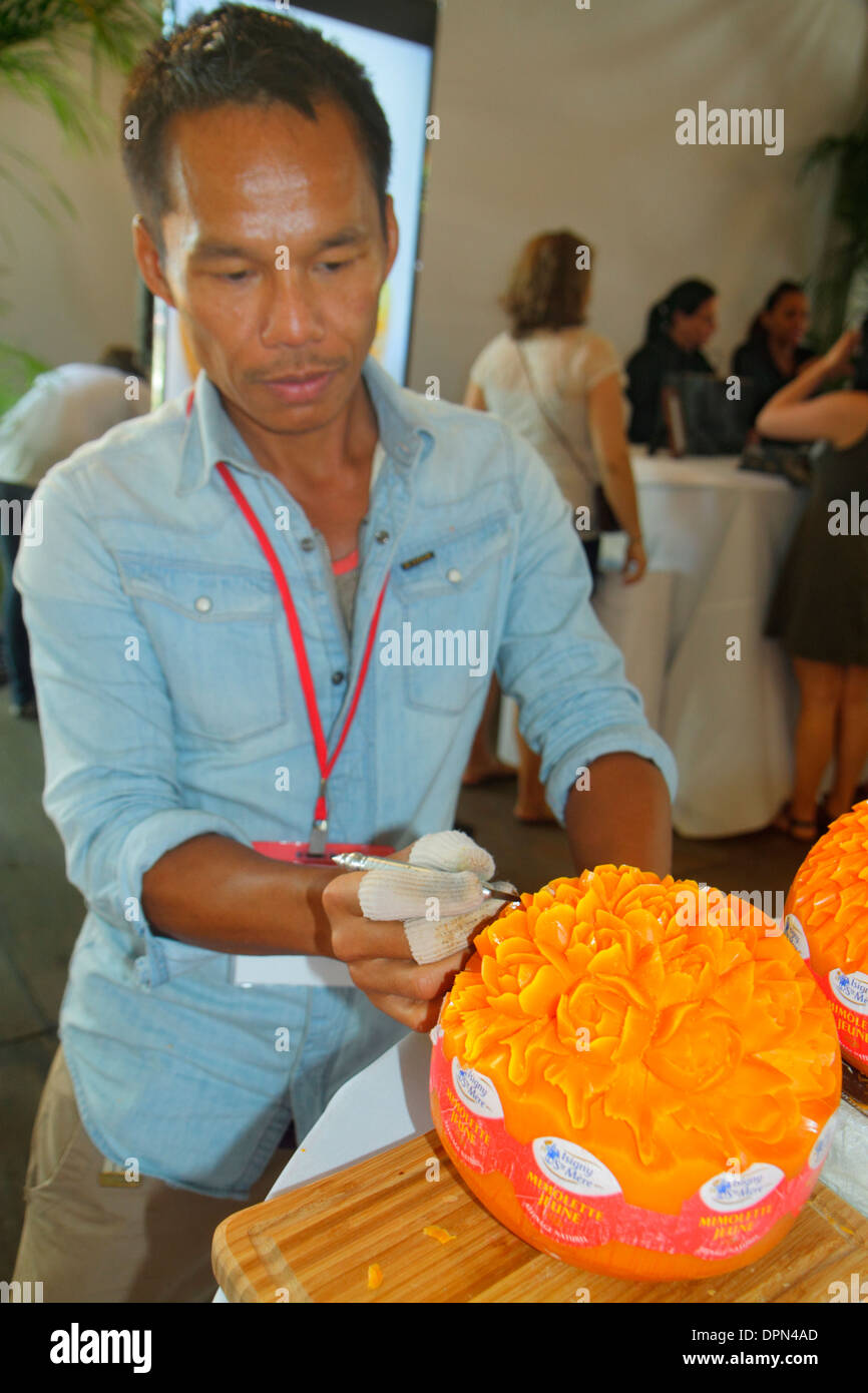 Miami Florida,Midtown,Art Miami,Art Basel,gallery,satellite fair,Eat Art,Asian man men male,sculpting,food,Mimolette,cheese,FL131231173 Stock Photo