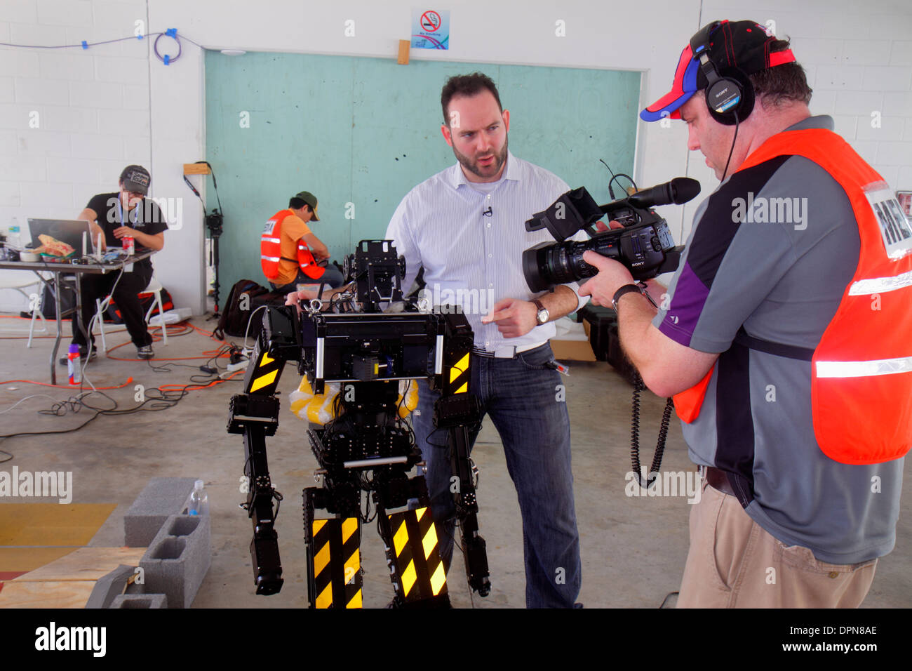 Miami Florida,Homestead,Speedway,DARPA Robotics Challenge Trials,remote controlled,robot,robots,engineer,explaining,demonstrating,journalist,reporter, Stock Photo