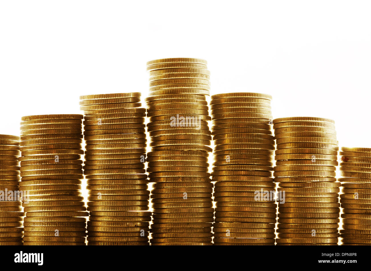 Golden coins in high stacks Stock Photo