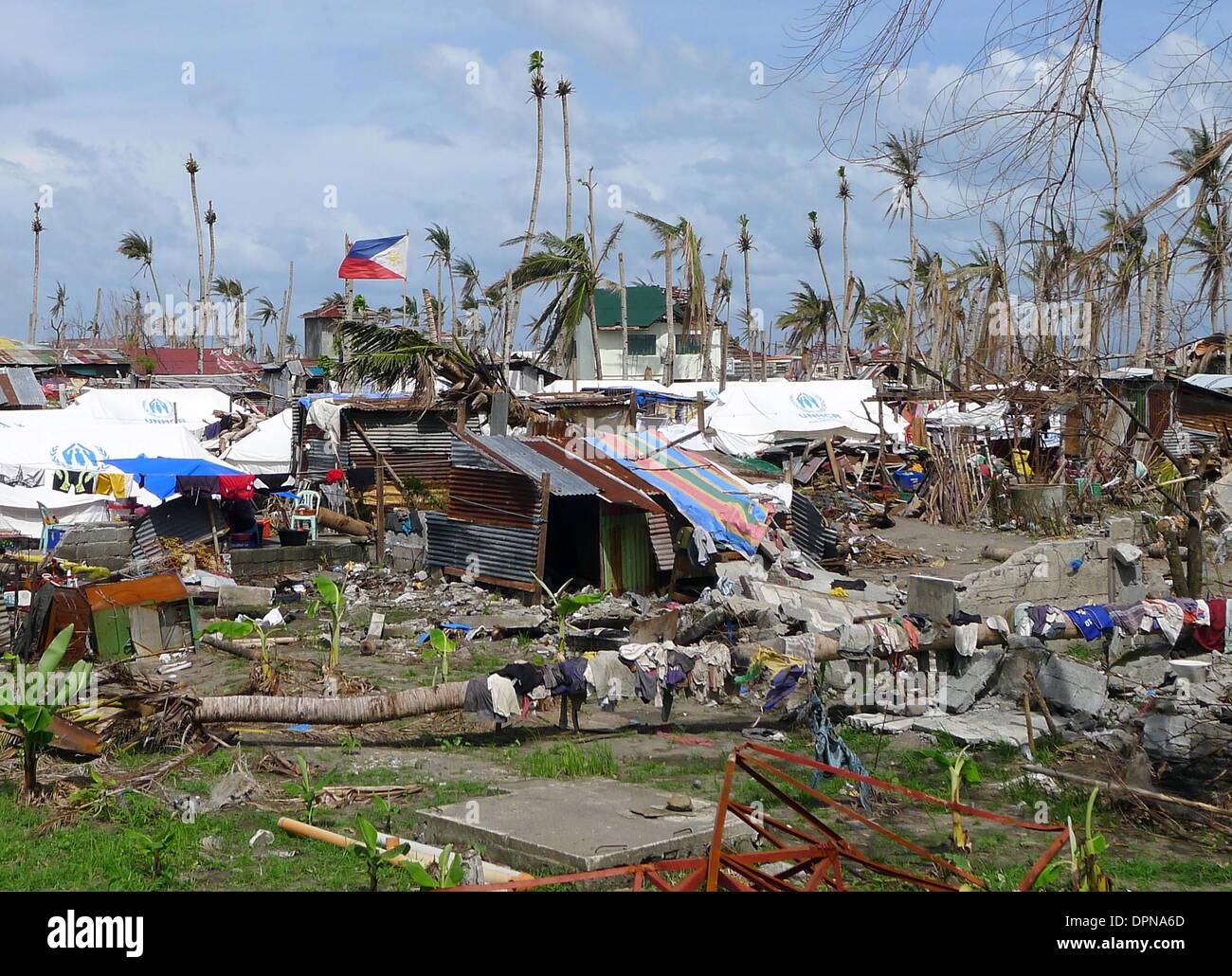 Tacloban, Germany. 15th Dec, 2013. Tents and emergency shelters stand amongst the destruction in Tacloban, Germany, 15 December 2013. A good two months after typhoon 'Haiyan' tore through the Philippines, the survivors are trying to rebuild their lives and homes. Photo: JOHN GRAFILO/dpa/Alamy Live News Stock Photo