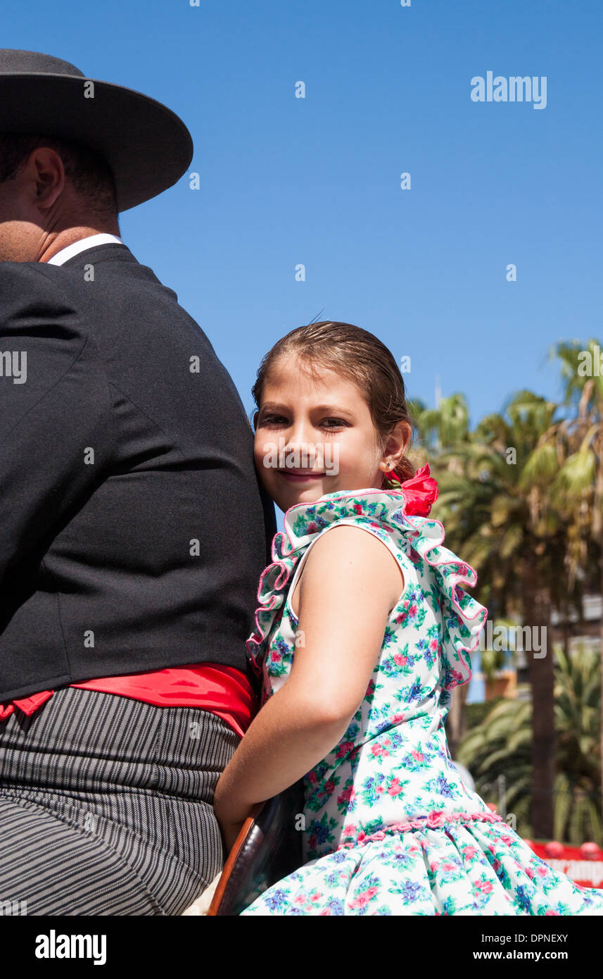 Young girl in Flamenco dress and red shoes at Feria de Abril Flamenco