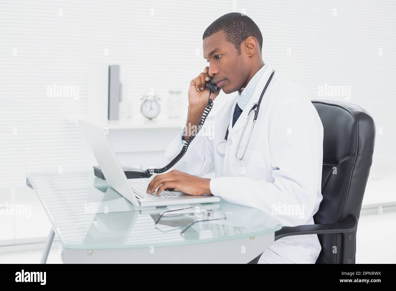 Male doctor using telephone hi-res stock photography and images - Alamy