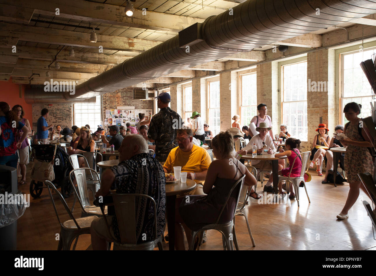 Dining area inside Mass MoCA [Massachusetts Museum of Contemporary Art] in North Adams Massachusetts filled with Wilco fans. Stock Photo
