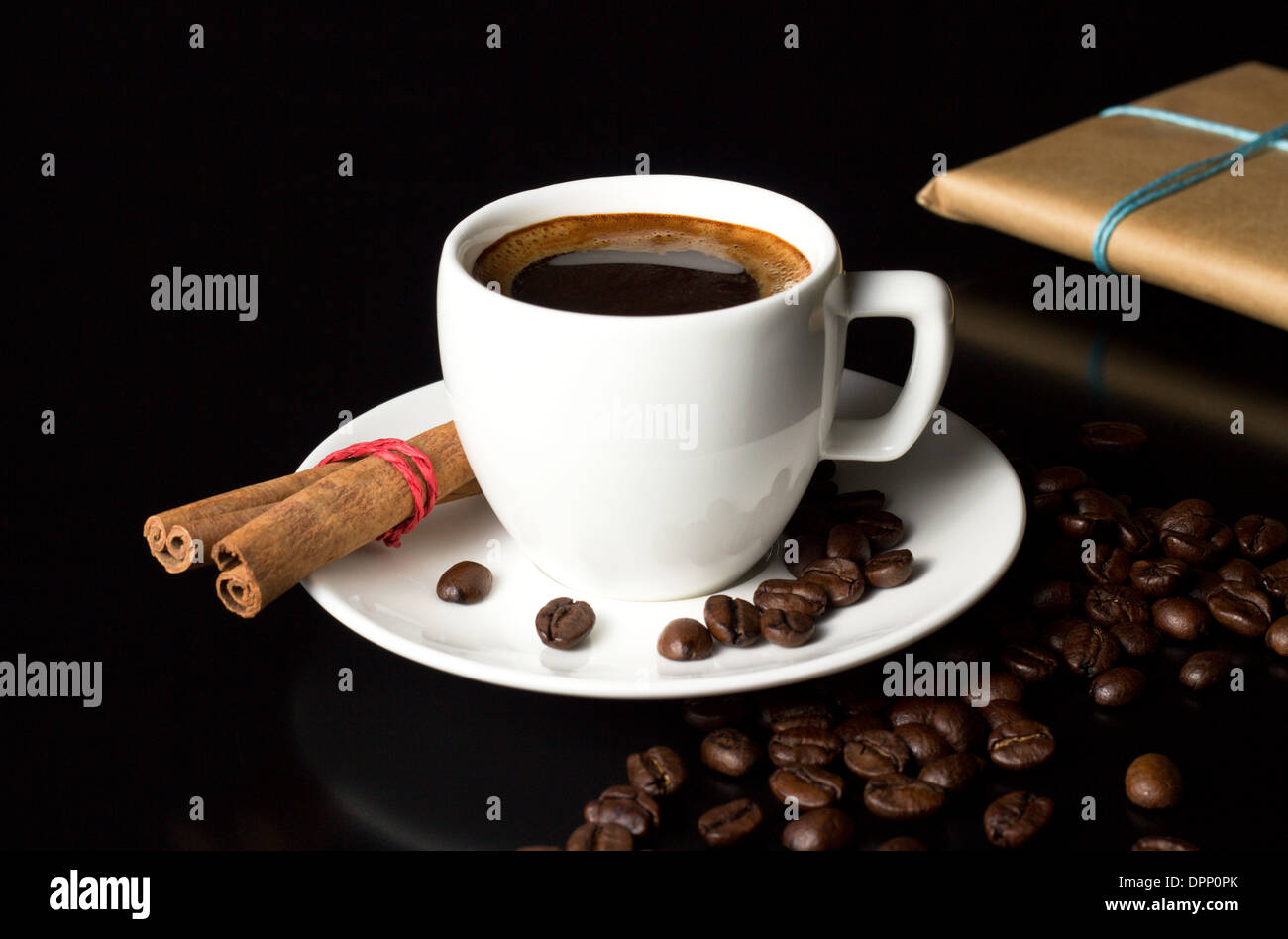 natural coffee cup with beans and gift on table Stock Photo
