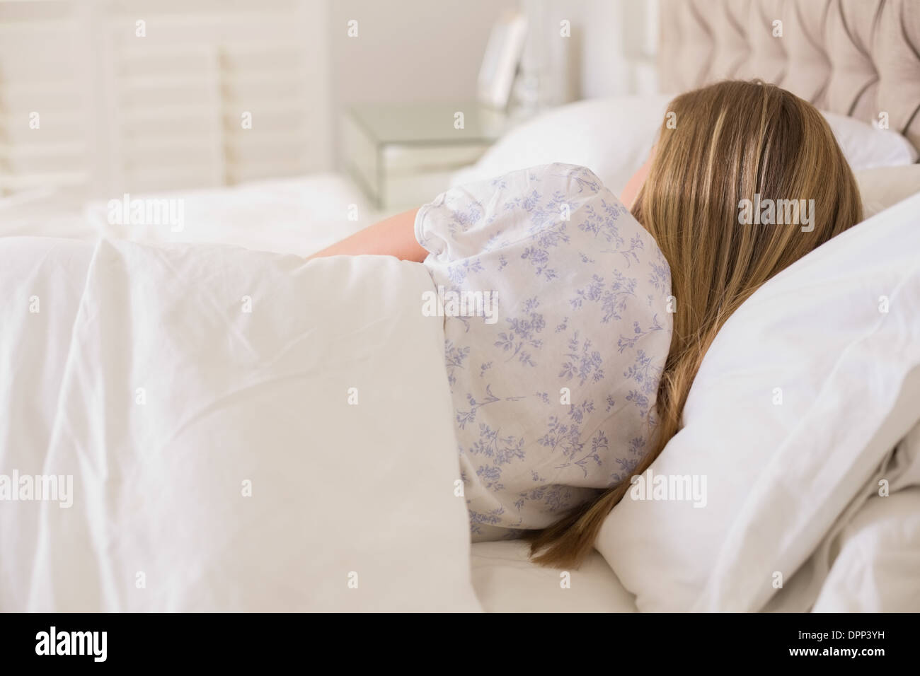 Natural woman slumbering in bed Stock Photo