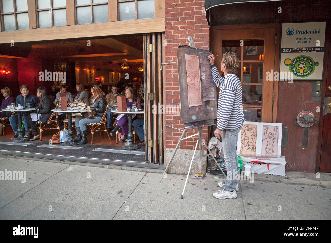 A man draws art on his easel on Newbury Street in Boston, MA, USA. Stock Photo