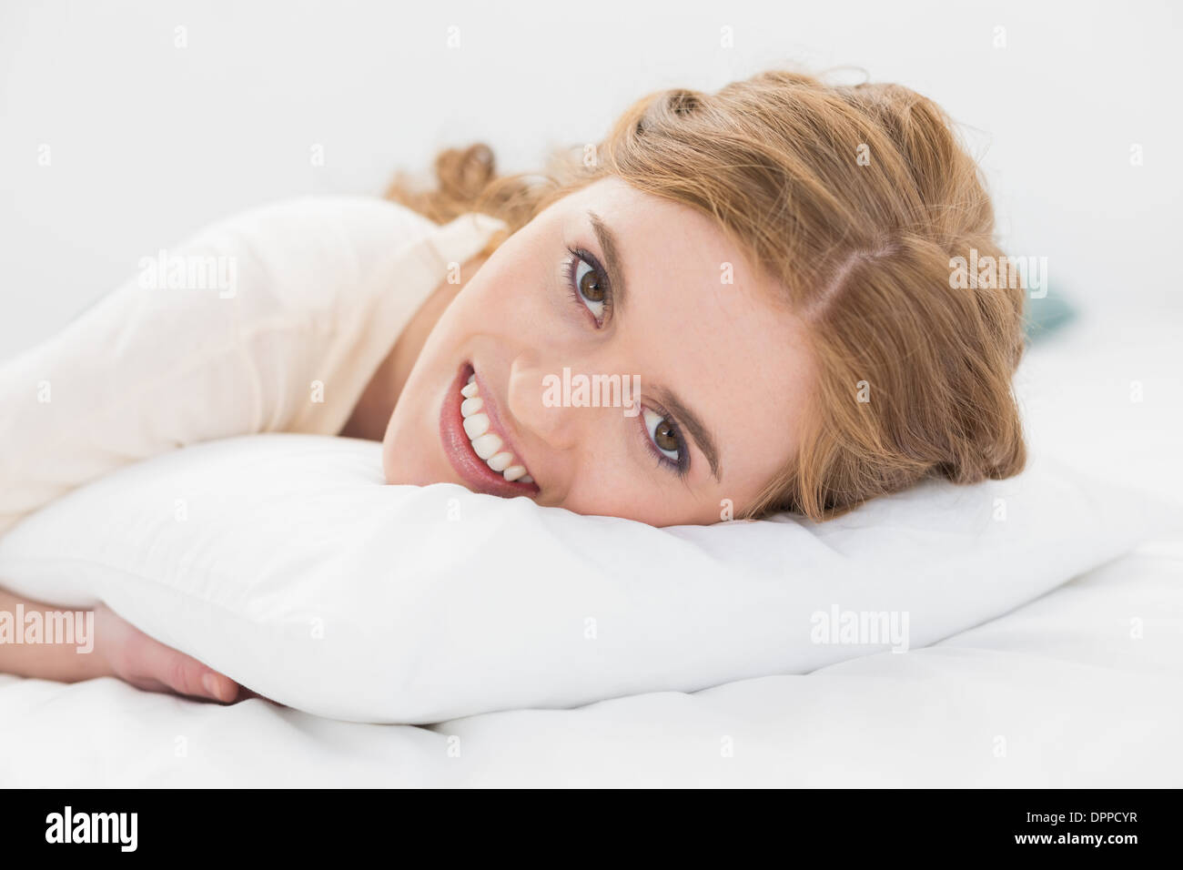 Close up of pretty woman resting in bed Stock Photo