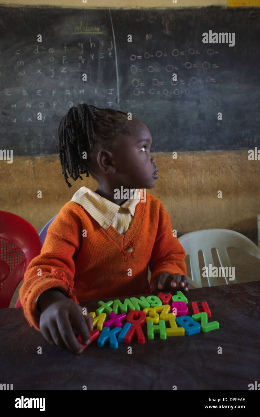 Primary age child student learning the alphabet at Rubiri Primary School, Naivasha, Kenya Stock Photo