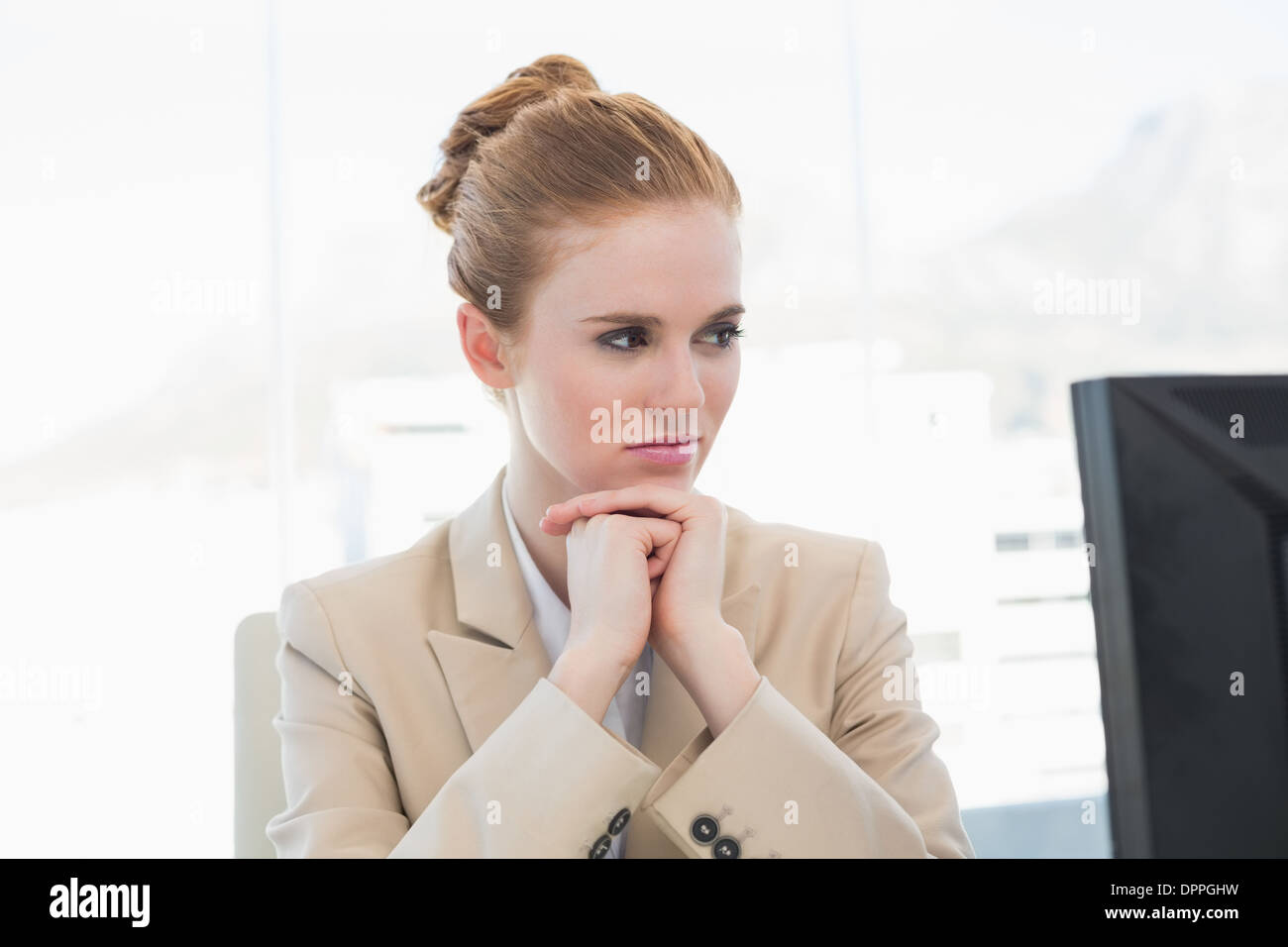 Worried young businesswoman looking at computer Stock Photo