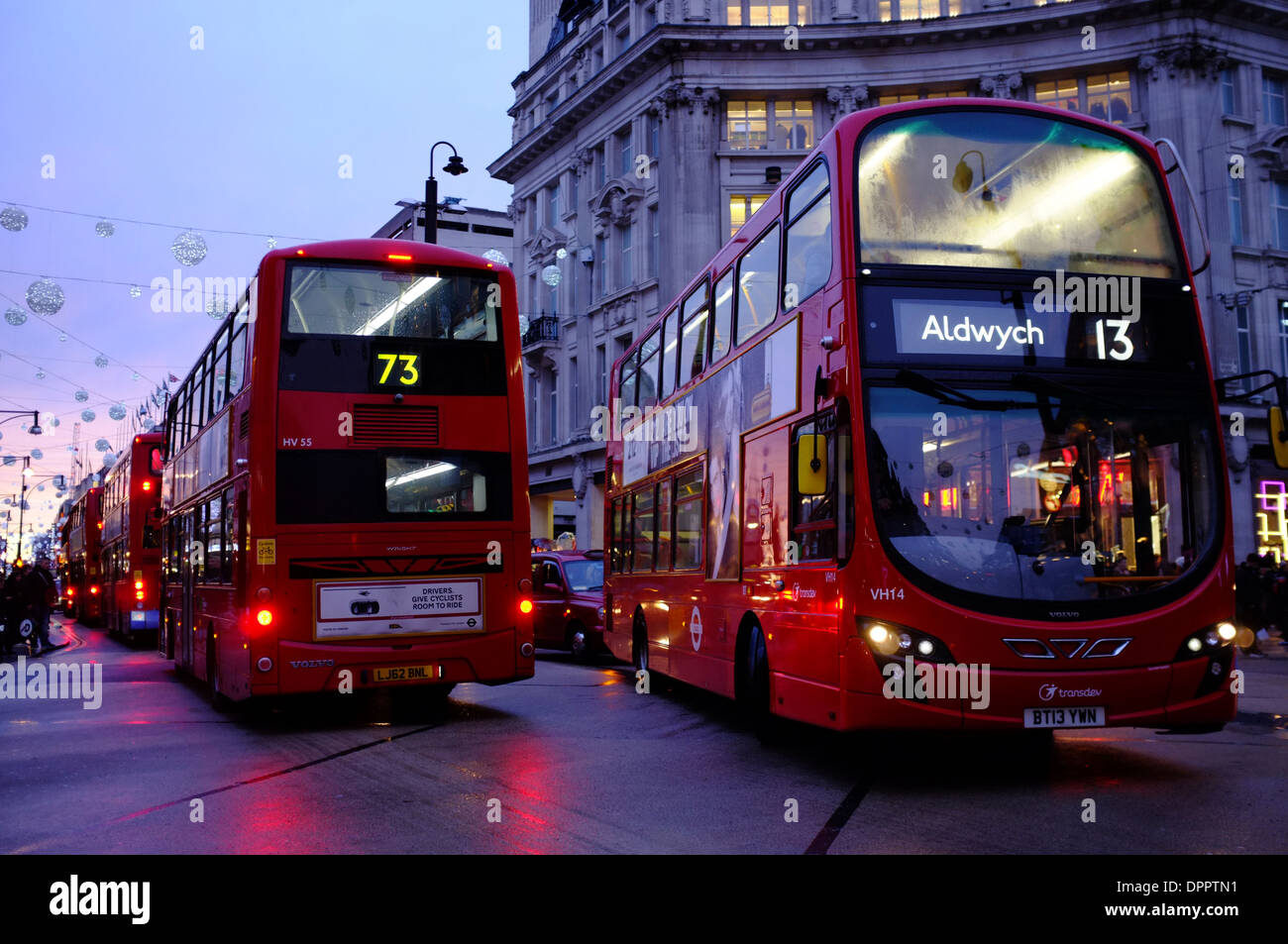 Red London Transport Buses in traffic at Oxford Circus, London Stock Photo