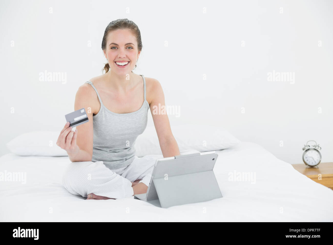 Casual doing online shopping in bed Stock Photo Alamy