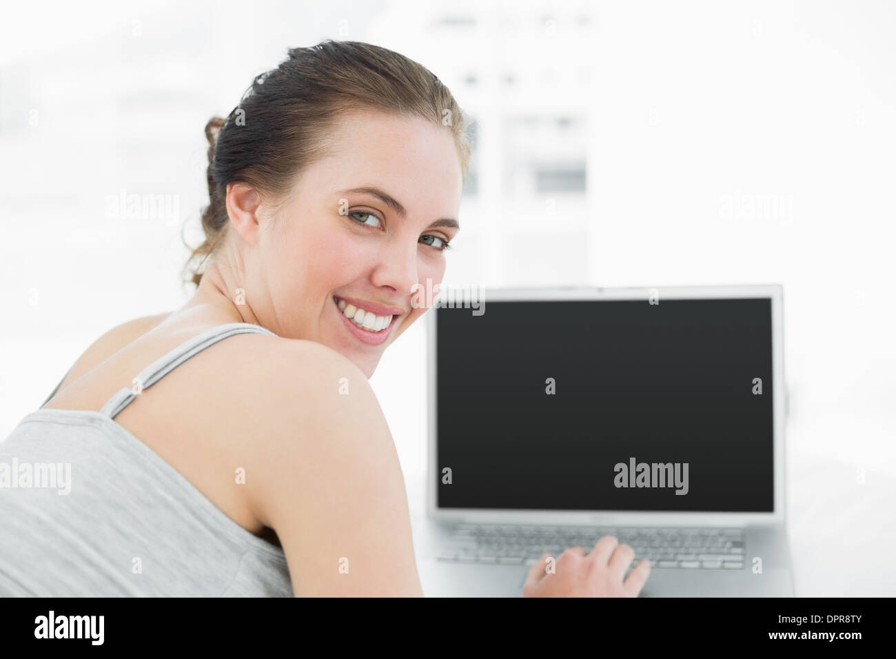 Close up portrait of a smiling casual woman with laptop Stock Photo - Alamy