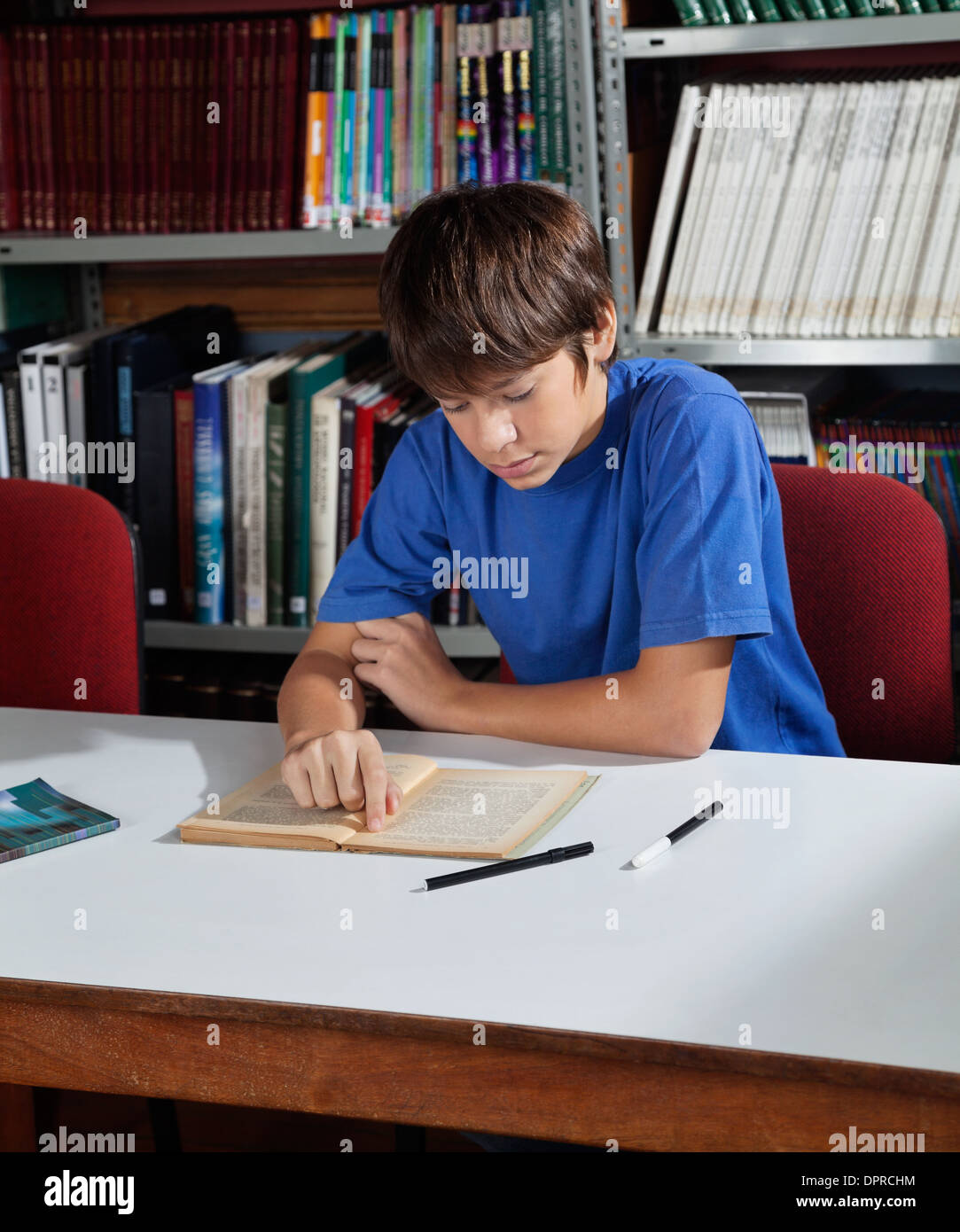 High School Student Studying In Library Stock Photo