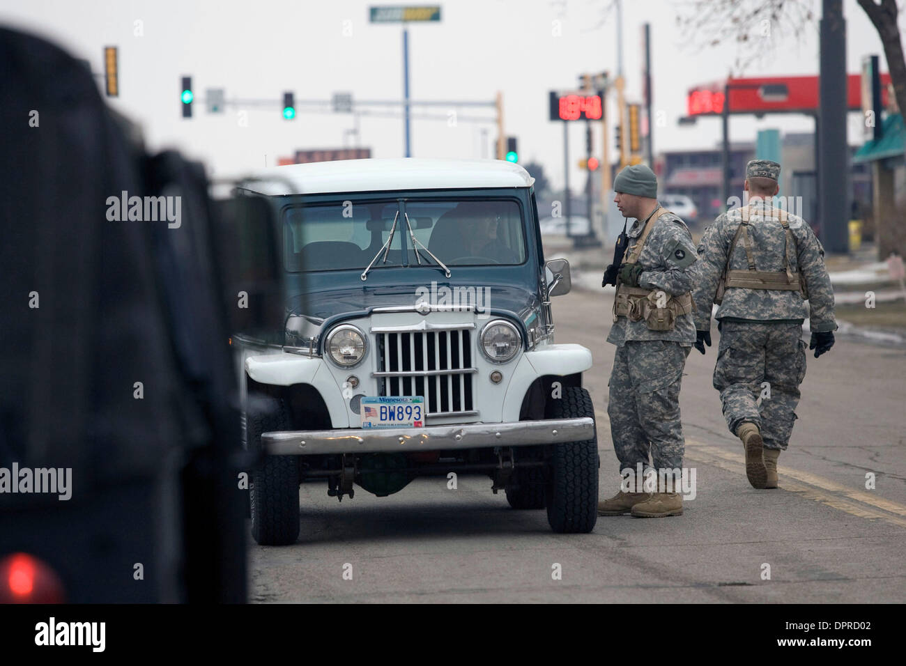 March 22, 2009 - Moorhead, Minnesota, USA - Minnesota Army National Guard troops monitor traffic entering neighborhoods along the Red River in Moorhead, Minn. The Red River along the North Dakota and Minnesota border is expected to crest at or near record levels in the coming week. Residents on both sides of the river are busy building dikes and sandbagging to fend off the rising w Stock Photo