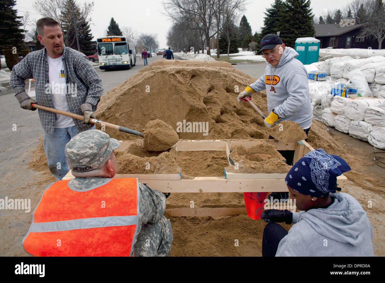 March 22, 2009 - Moorhead, Minnesota, USA - MATT CODGILL, left, of Fargo, N.D. and TIM ZOERNER, right, of Moorhead, Minn. fill sandbags with other volunteers and Minnesota Army National Guard troops in a neighborhood along the Red River in Moorhead, Minn. The Red River along the North Dakota and Minnesota border is expected to crest at or near record levels in the coming week. Resi Stock Photo