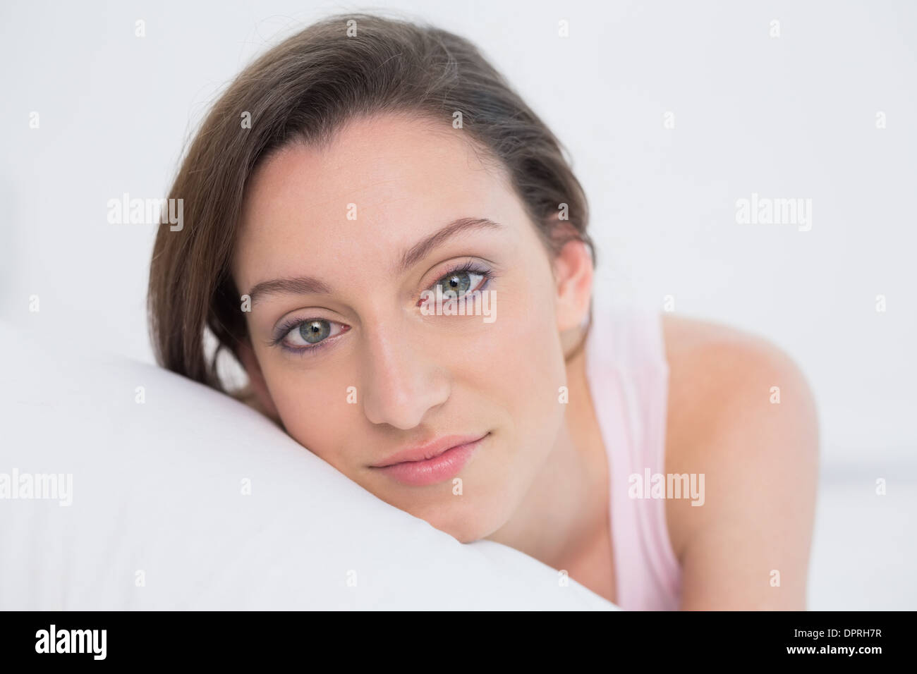 Close up portrait of a pretty woman resting in bed Stock Photo