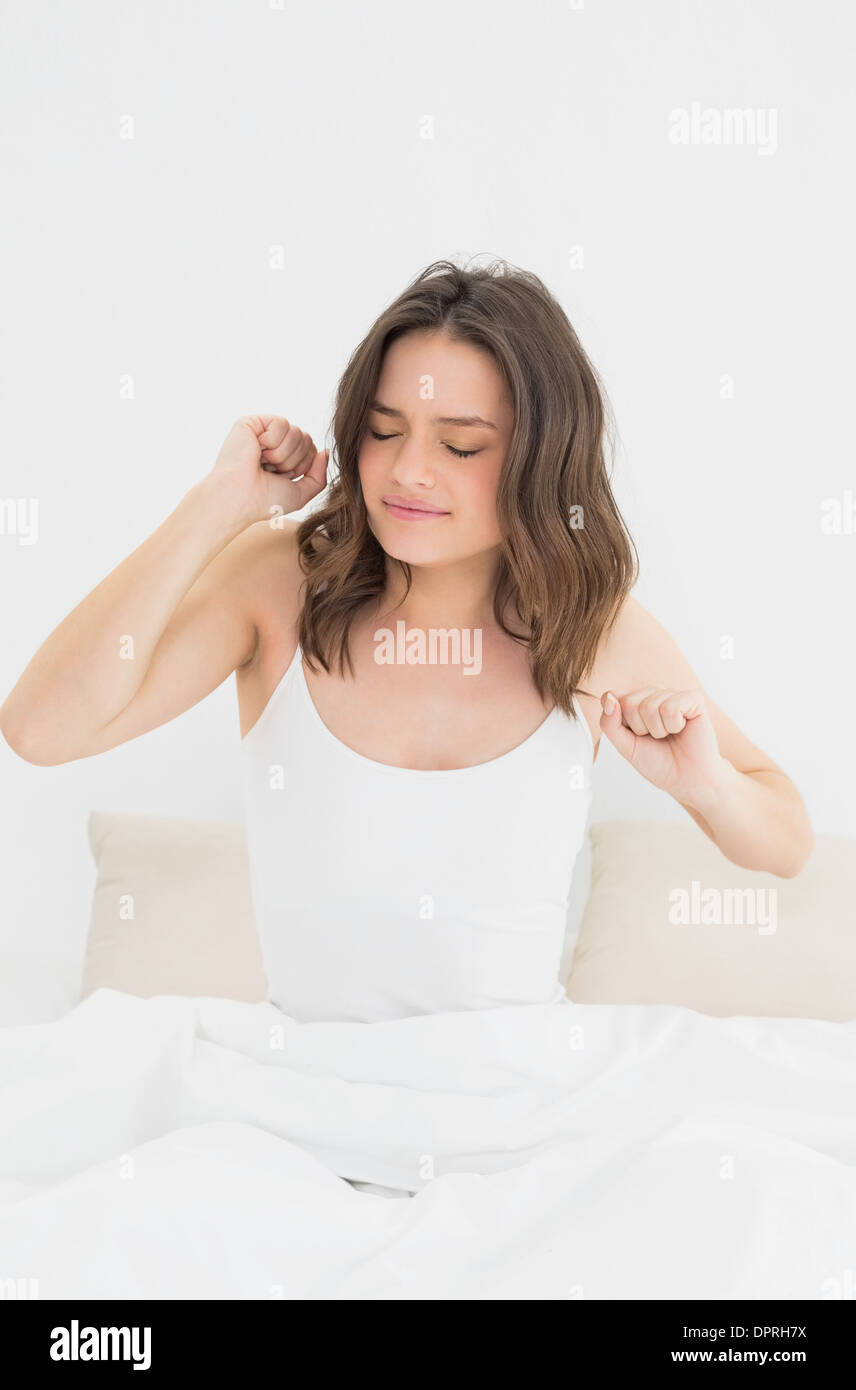 Woman waking up in bed with eyes closed Stock Photo Alamy