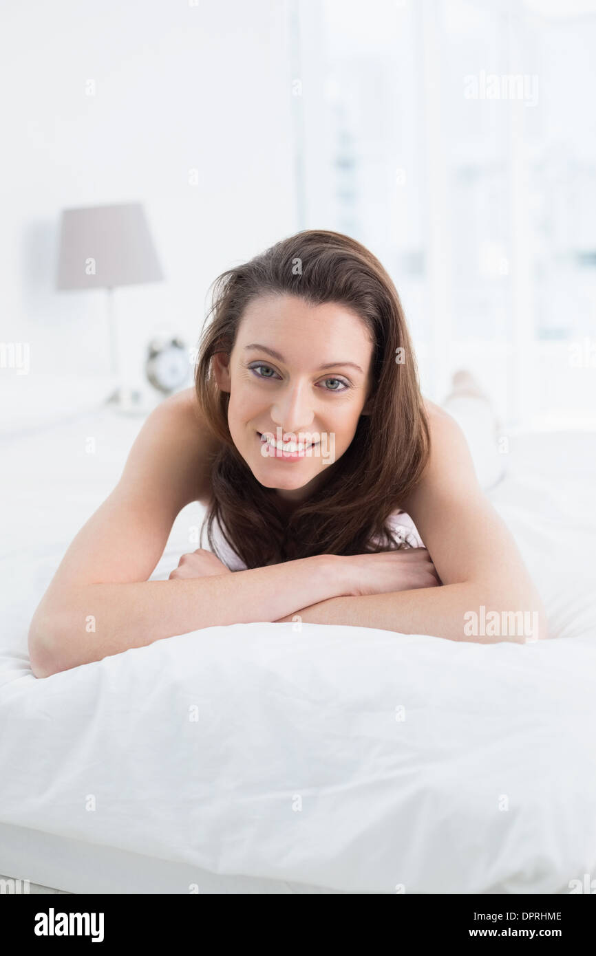 Close up portrait of pretty happy woman resting in bed Stock Photo