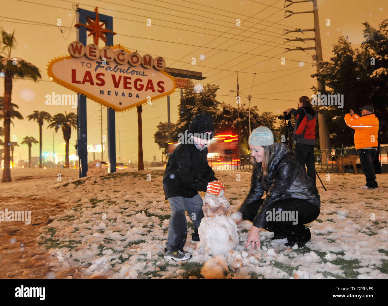 Dec 18, 2008 - Las Vegas, Nevada, USA - LANDEN SEVERSON, 6 with his mom,  CARLY WARD, construct a snowman at the foot of the welcome to Las Vegas  sign along the