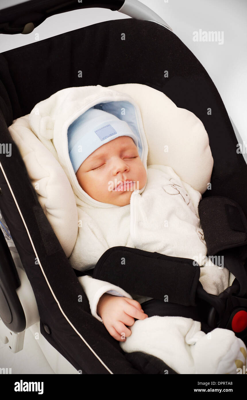 Little baby boy sleeping in car seat Stock Photo