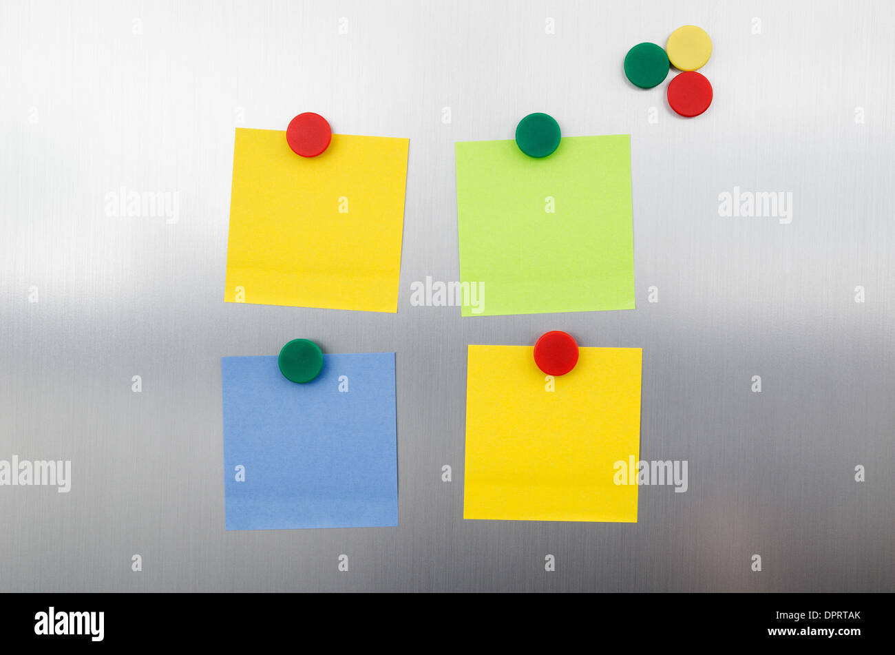 Coloured notes and magnets on inox metallic fridge Stock Photo