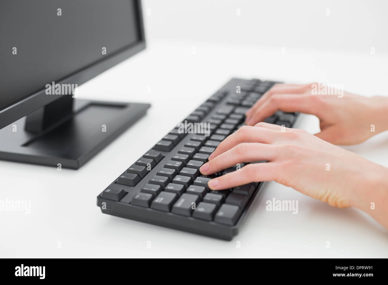 Hands typing on keyboard in an office Stock Photo