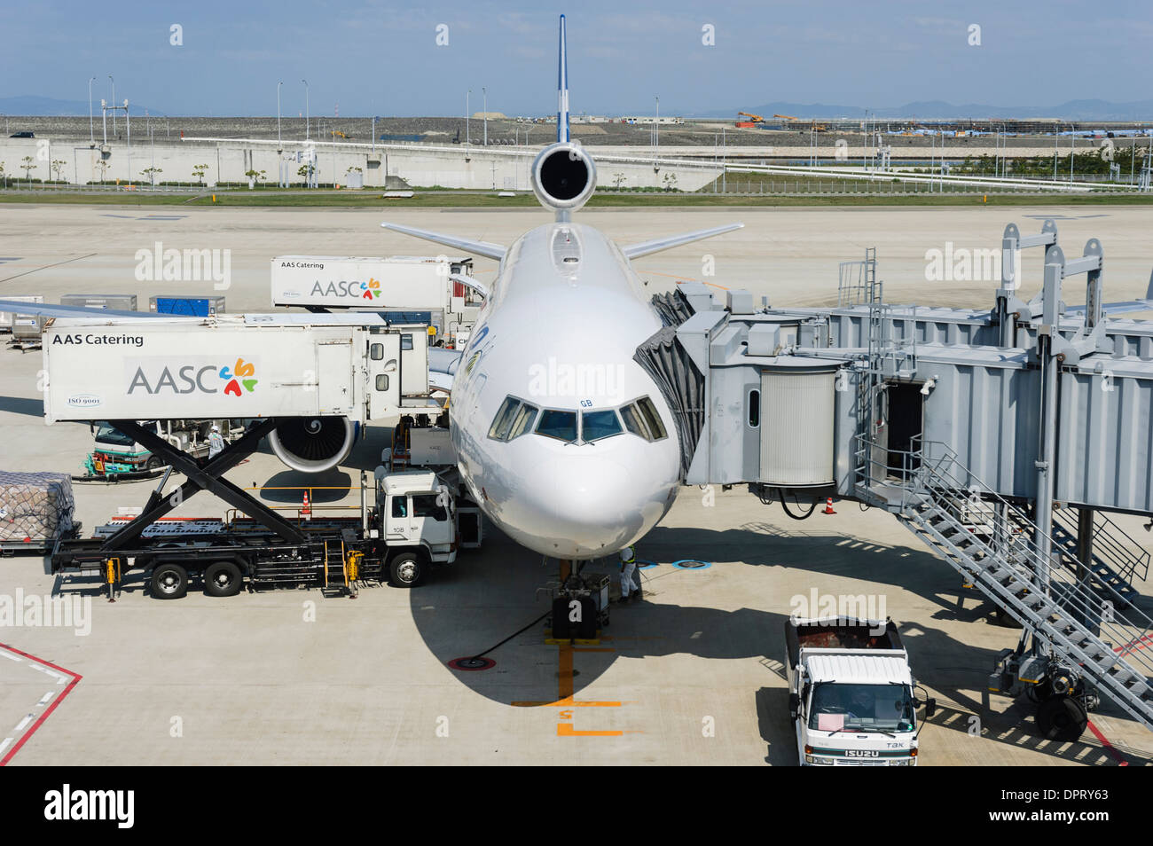Plane being loaded; preparing for departure with airbridge attached
