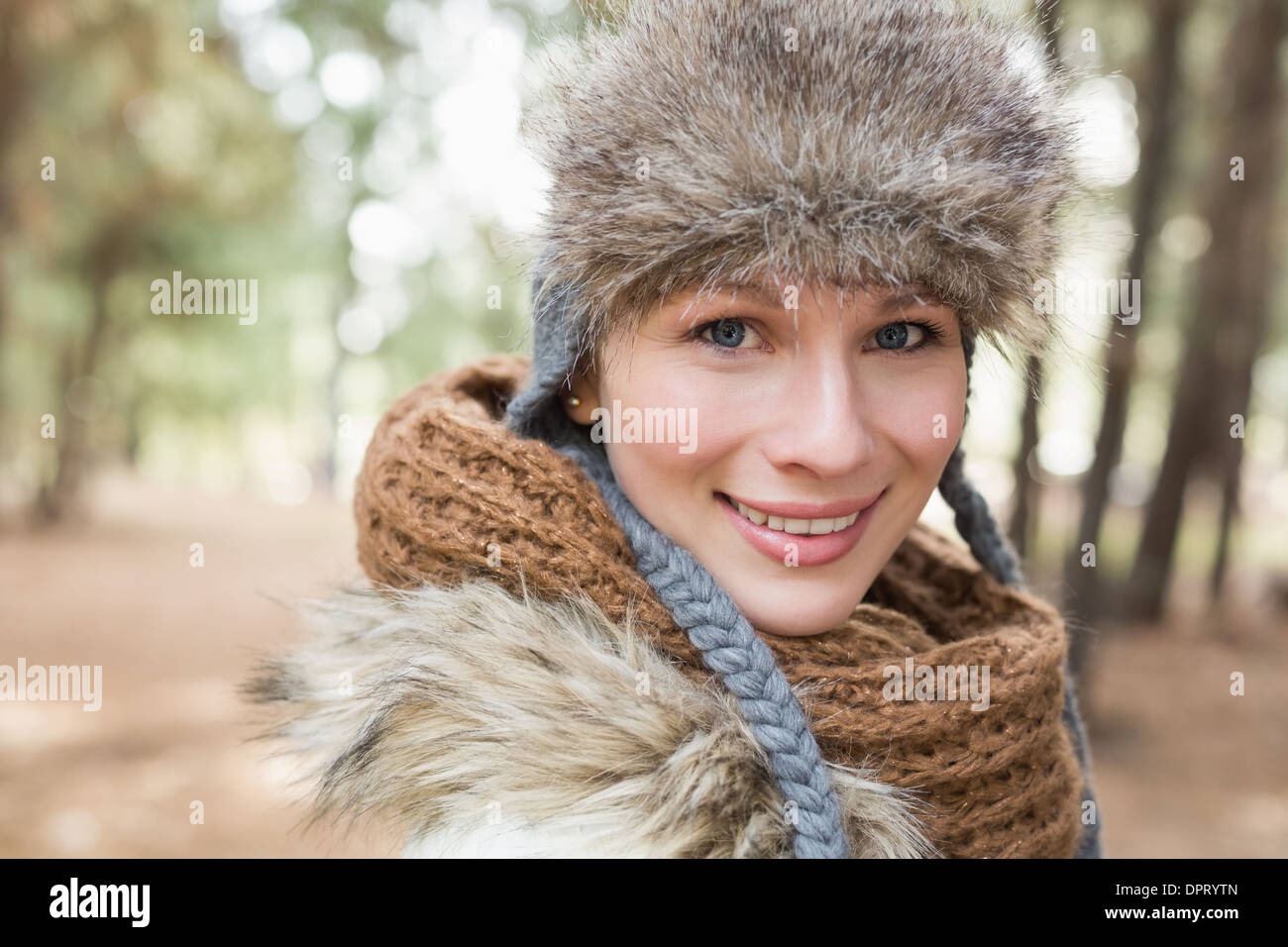 Woman in fur hat with woolen scarf in the woods Stock Photo - Alamy