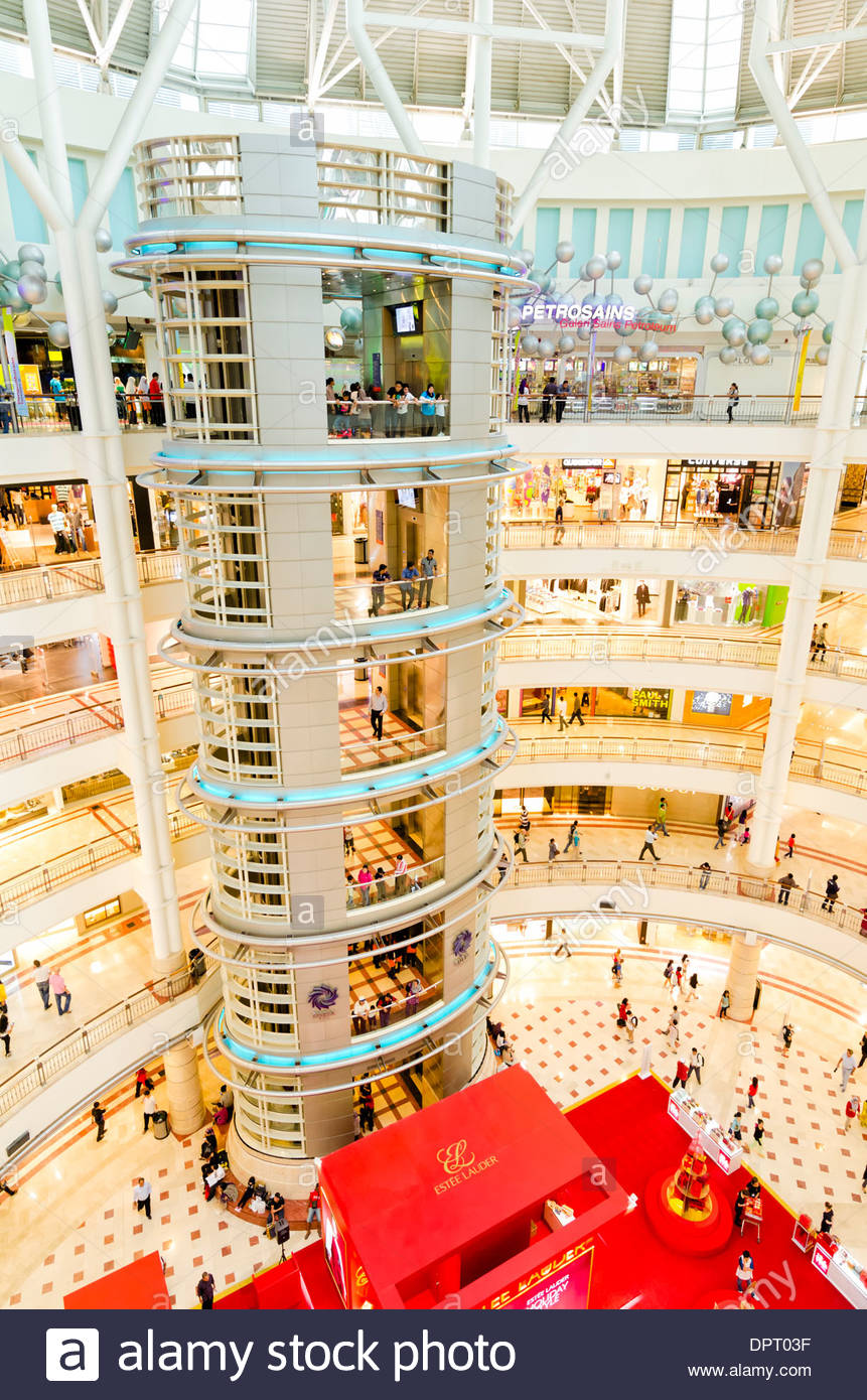 Very modern multistory Asian shopping centre with glass life / elevator Stock Photo
