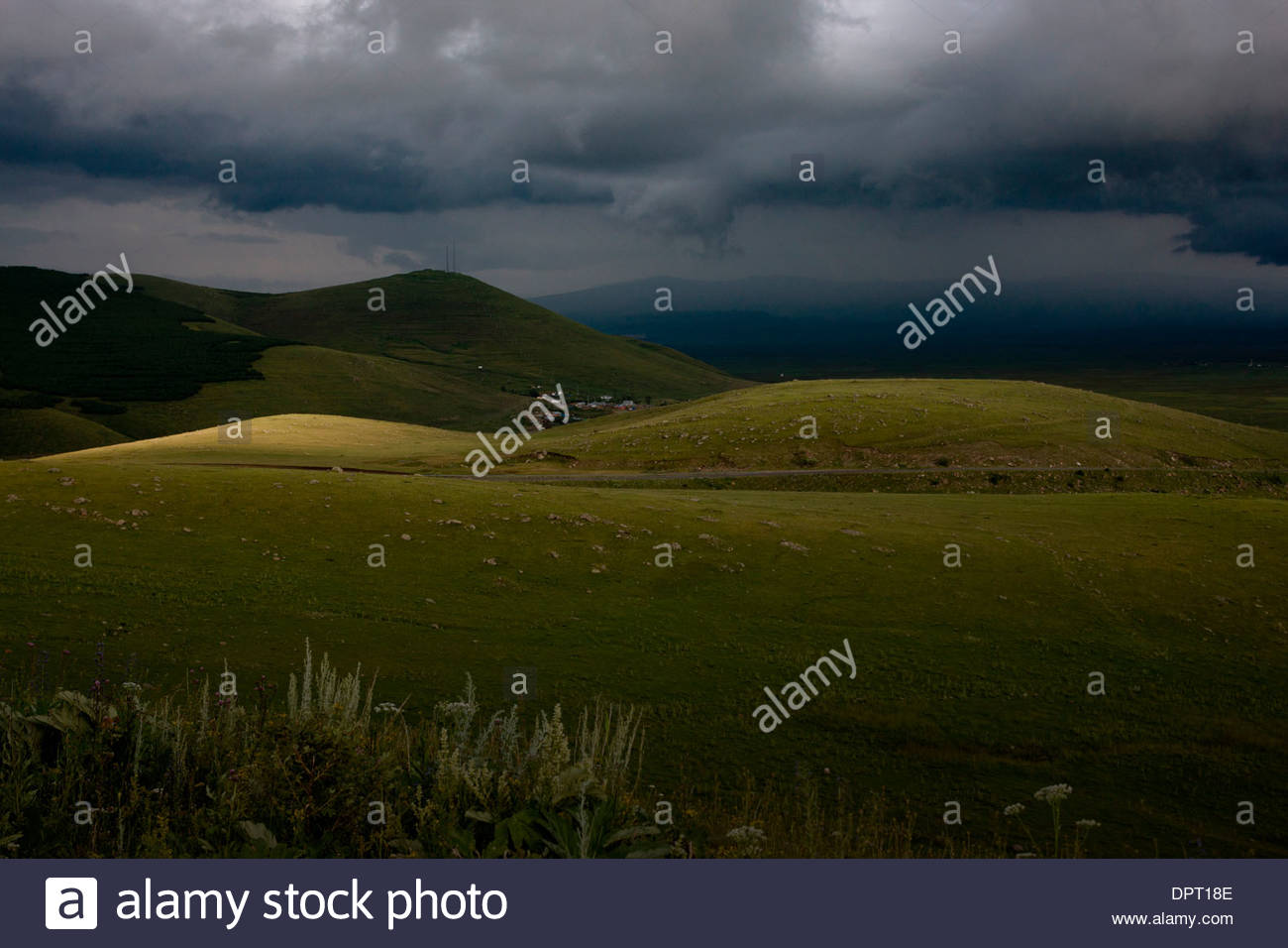 Light and shade in stormy weather over steppe grassland on the eastern side of the Cam Pass (Cam Gecidi) in north-east Turkey. Stock Photo