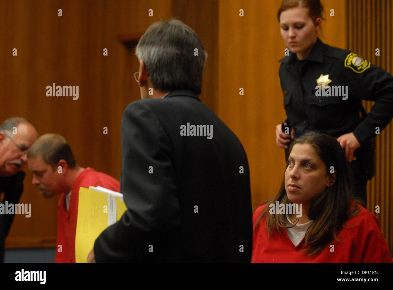Michael Luther Schumacher, second from left, speaks with his attorney