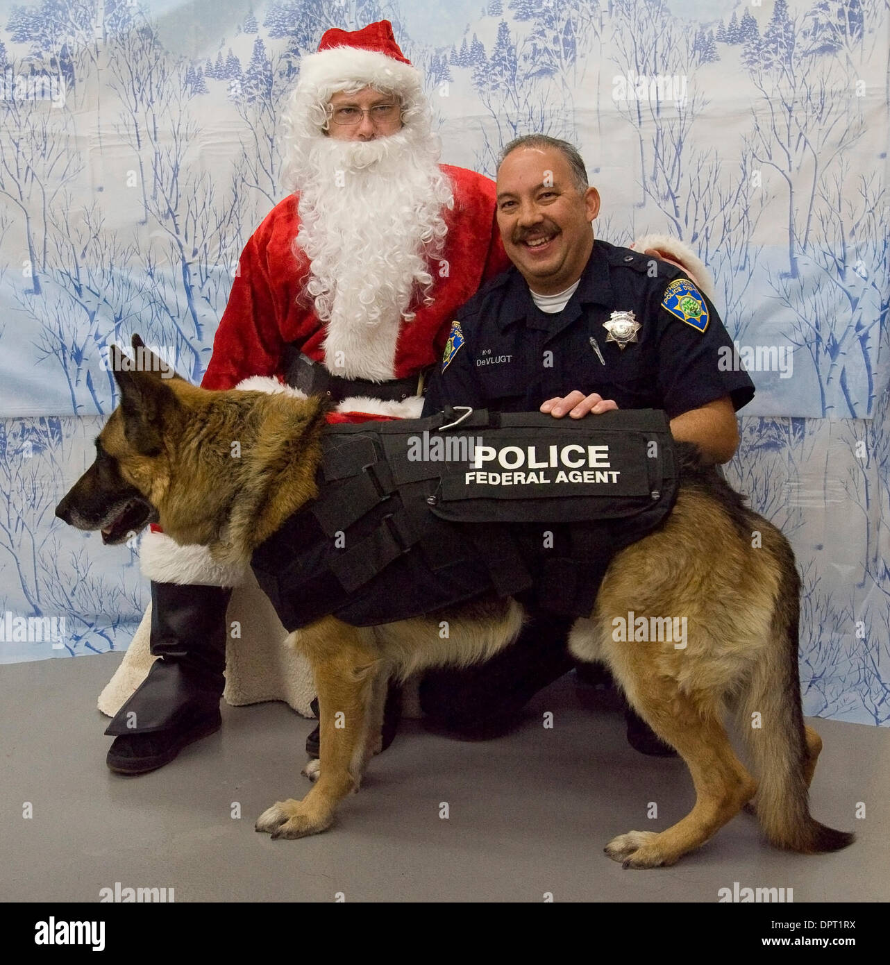 Menlo Atherton police officer Dean DeVlugt and his dog Zar, pose for a