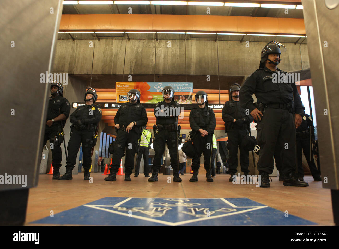Oakland Police officers stand guard as protesters block the entrance to