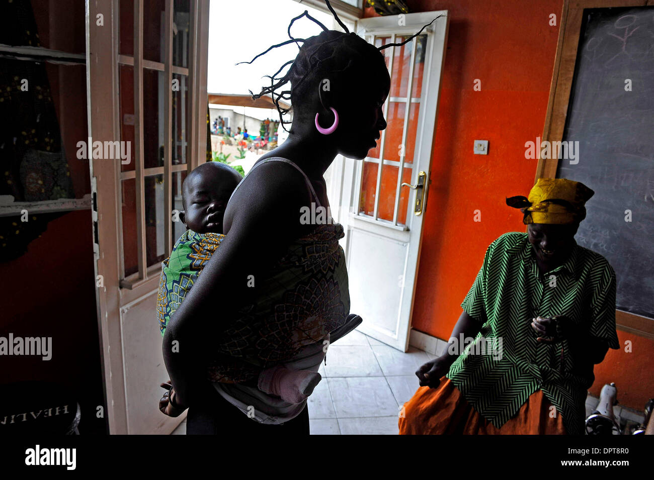 Apr 15, 2009 - Goma, Congo - Santa Mapenzi, 16, was raped when she was 14 years old and became pregnant with her son, Simeni. ''I was back at my home, and I was studying. I was a student and coming from school late at night when they raped me,'' she says, ''I heard about HEAL Africa, and they told me I could learn how to sew until I can go back to school. Mapenzi has spent three mo Stock Photo