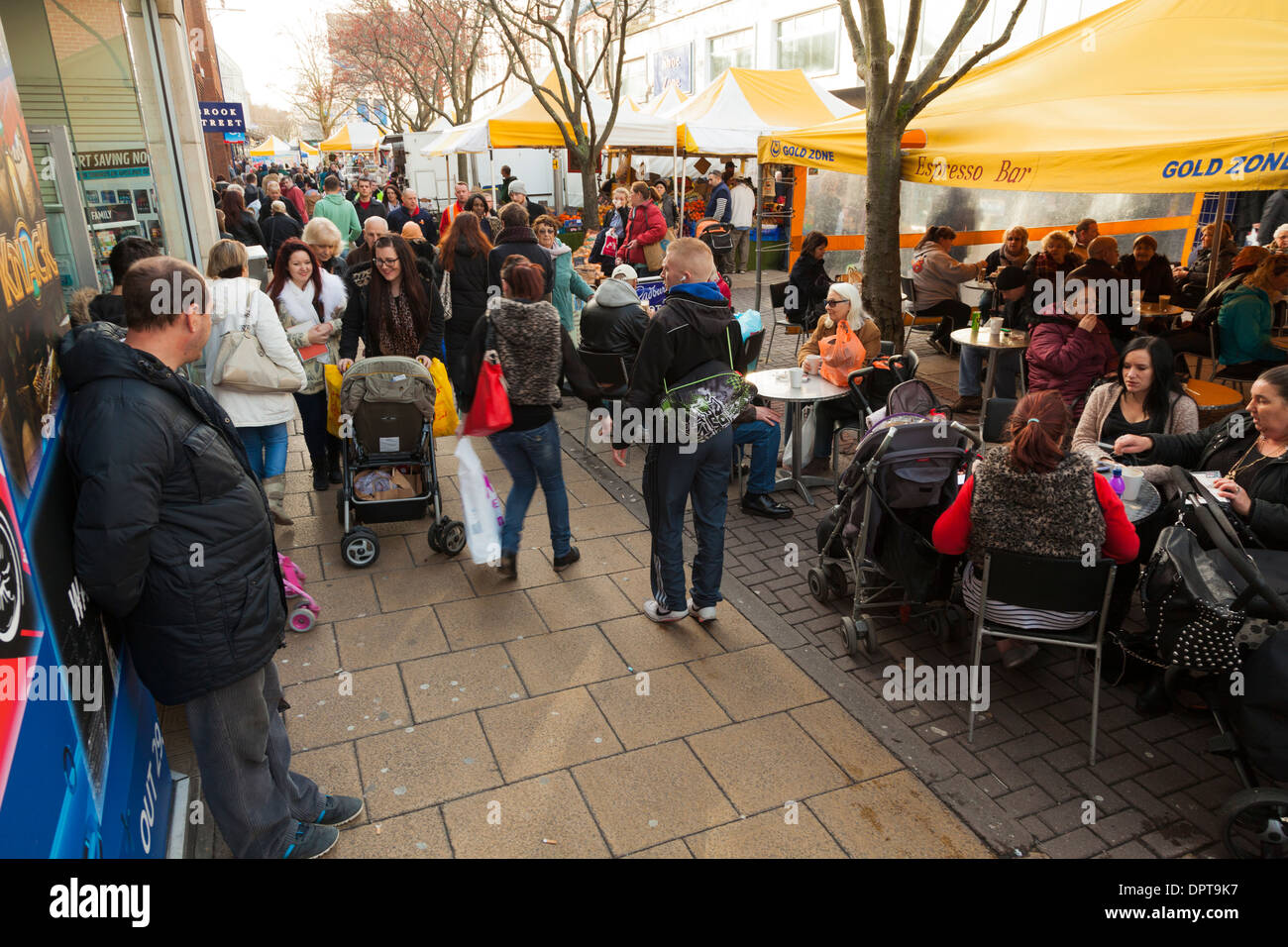 Busy shopping high street with street cafe. Stock Photo