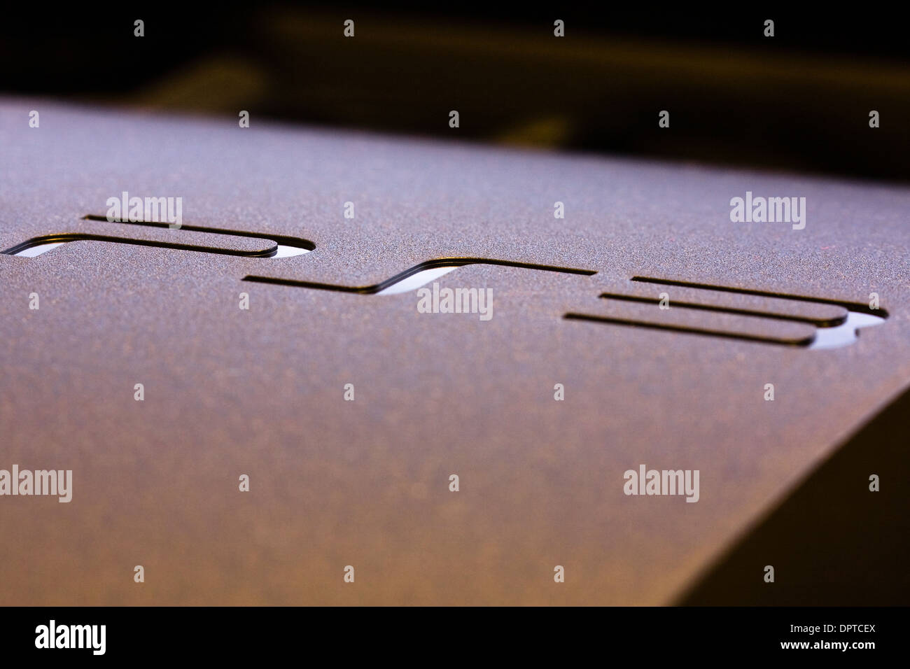 Incised letters on the top of a Playstation 3 Game Console Stock Photo