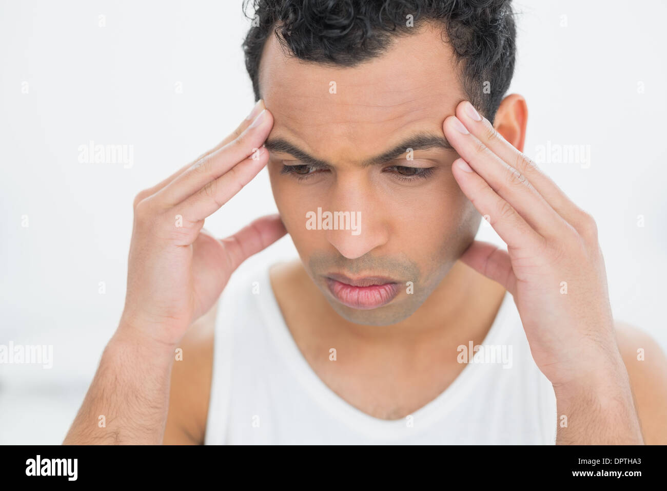 Close-up of a young man suffering from headache Stock Photo