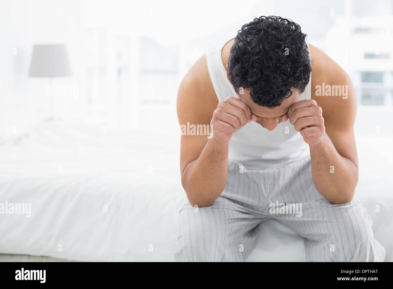 Young Sleepy Man Rubbing His Eyes On Bed Stock Photo Alamy