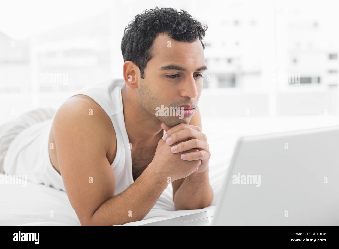 Man using laptop bed hi-res stock photography and images - Alamy
